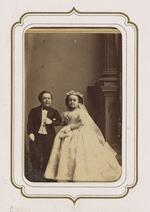 From the Fairy Wedding Album: Charles S. Stratton and M. Lavinia Warren in their wedding clothes standing arm in arm (version 3)