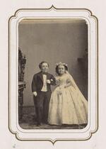 From the Fairy Wedding Album: Charles S. Stratton and M. Lavinia Warren in their wedding clothes standing arm in arm (version 4)