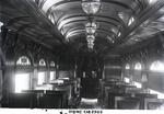 Interior view of New Haven Railroad dining car 2303, "Bronx," with ornamental arched windows