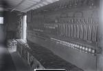 Interior view of tool car, shows sledge hammers, saws, and padded bench