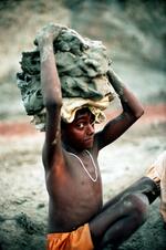 Bonded (slave) Child Laborer Carrying Clay At A Brick Kiln