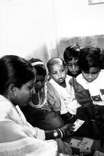 Students Looking At Flashcards At The Pudar School For Street Children