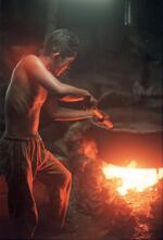 Boy Works To Boil Teri (small Fish)