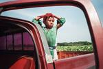 Boy Waits For A Ride Home After Working In The Tobacco Fields