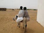Two boys ride a donkey outside Oure Cassoni refugee camp in Chad