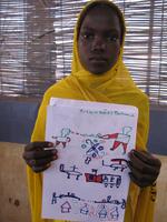 Girl in the Djabal Refugee Camp holds a drawing of the violence she witnessed