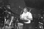 Man in the midst of playing the drums