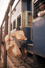 Ragpicker Scrambles To Hitch A Ride On The Train