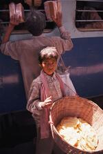 Child Sells Bread On A Train Platform