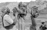 All Bonded (Slave) Laborers, A Mother Loads Clay Onto The Heads Of Her Children