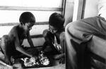 Train Children Eat Food Off Of A Tray On The Train Floor