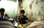 Boy Operates A Sewing Machine
