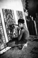Underage Worker Working On A Tufted Rug
