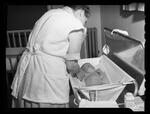 Handicapped Homemakers Project, Mrs. Wilson bathing a child
