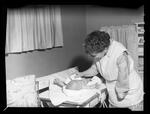 Handicapped Homemakers Project, Mrs. Wilson bathing a child