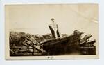 Charles Olson standing aboard wrecked boat
