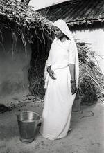 Bihar Woman Poses Next to Wattle Bucket