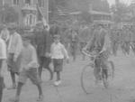 Men playing lawn games; parade; home movie, 1915 or 1916