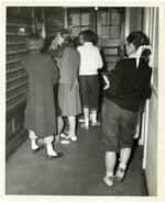 Students checking mailboxes in Hillyer Hall post office