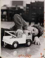 Boy playing with toy tow truck