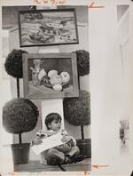Child sitting below artwork display, October 11, 1974