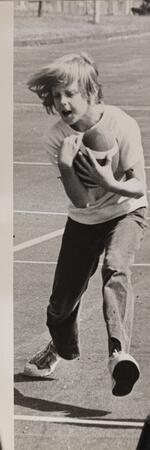 Boy holding football, August 6, 1973