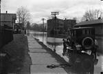 Car and flooded residential street, Hartford, possibly 1924