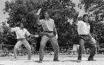 Three young men dance with similar movements at Peace Train's Breaking & Popping Contest, Bushnell Park
