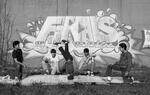 Baby Elias in a headstand, breakdancers in front of Finals graffiti mural, Hartford, 1984