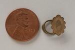 Physical object: Cufflink belonging to Charles S. Stratton (with penny for scale)