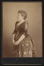 Photograph: Nancy Fish Barnum in dark color gown with embroidered and beaded details
