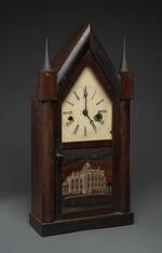 Physical object: Gothic mantle clock with a glass panel featuring Barnum's Iranistan home