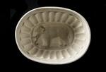 Physical object: Ironstone pudding mold with elephant, overhead view